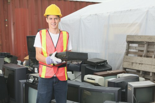 Sorting area showing separated recyclables like paper, cardboard and glass